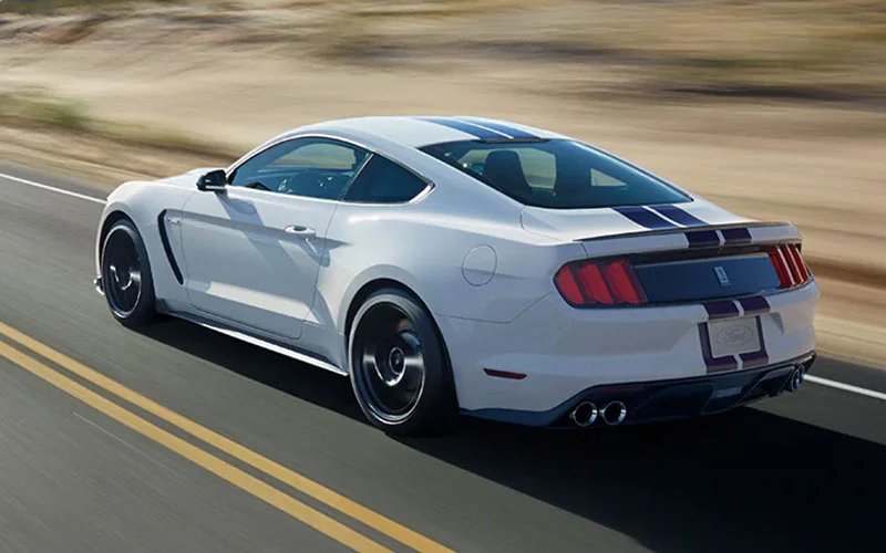 image of white ford mustang driving