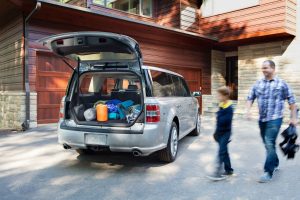 father and son loading up the back of their 2018 Ford Flex