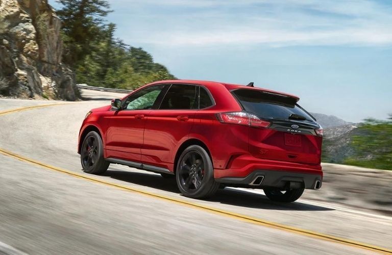 A red 2022 Ford Edge driving up the mountain road.