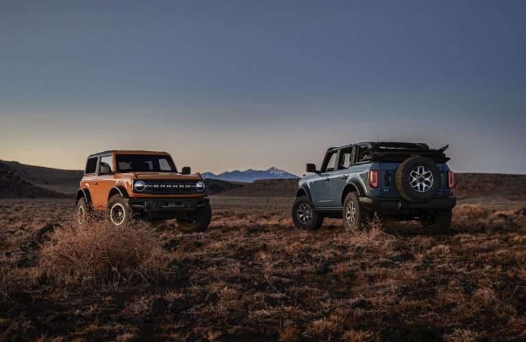 Orange and Blue 2022 Ford Bronco Front and Rear Exteriors in a Desert