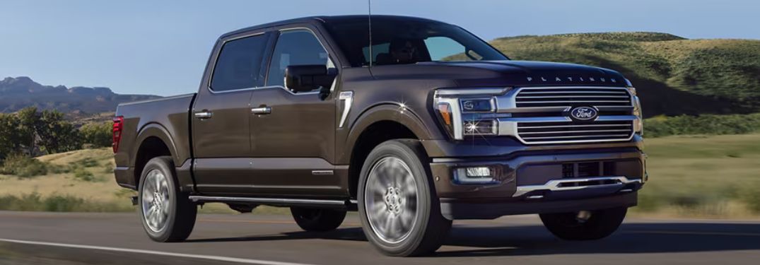 Bronze 2024 Ford F-150 with PowerBoost Hybrid on a Country Highway