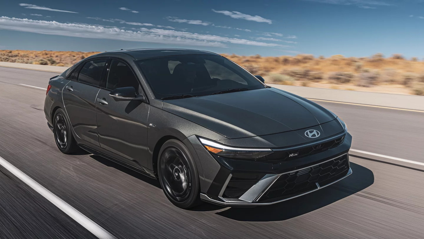 A black 2024 Elantra driving on the road.