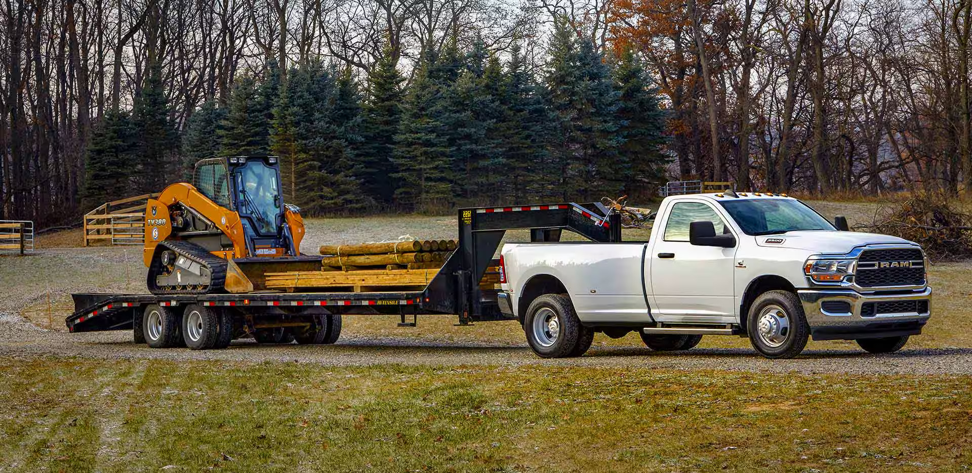 White Ram 3500 pulling a trailer with a bulldozer.