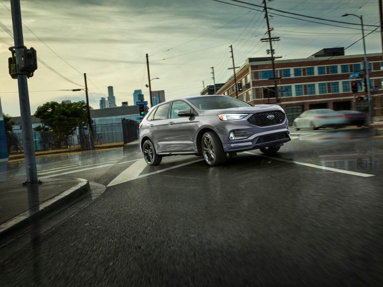 2024 Ford Edge driving through rainy streets