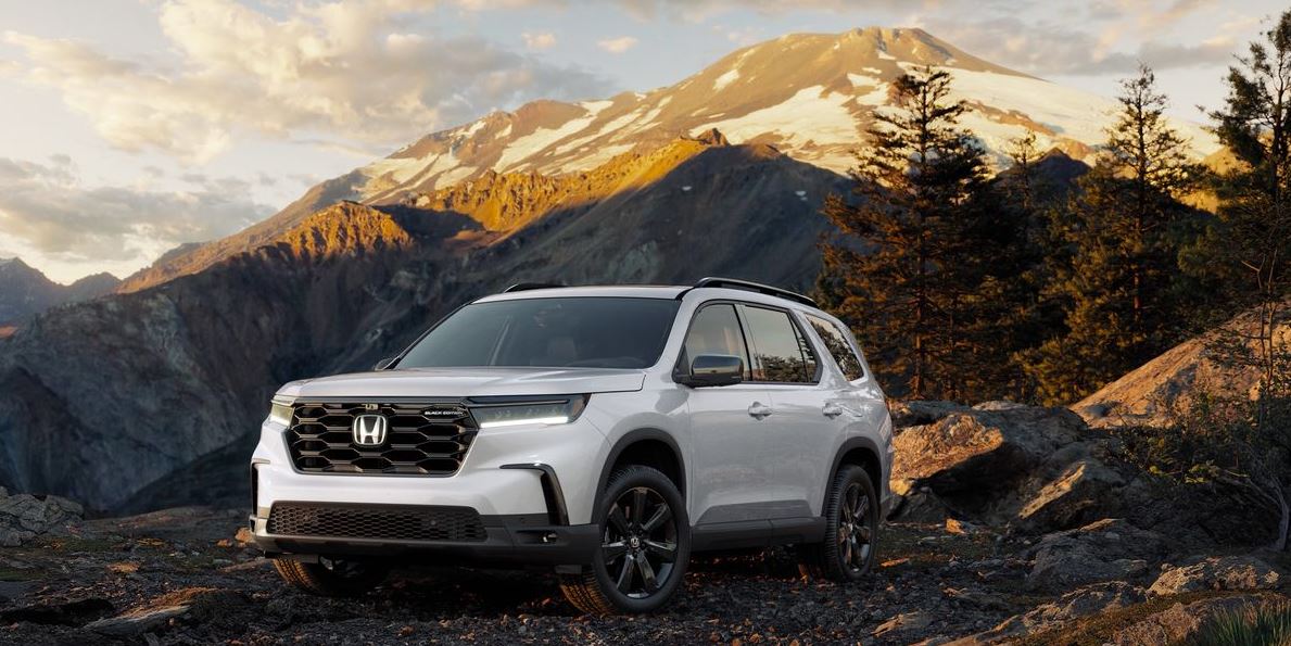 white 2025 Honda Pilot pictured with mountains in the background