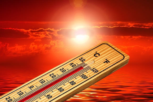 Theromometer showing high temps with a blistering sun in background