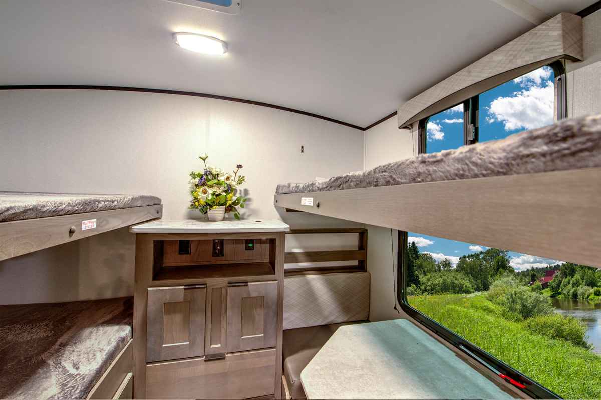 A bunkhouse camper with bunk beds, travel trailer and tow vehicle