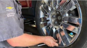 Chevrolet service technician installs a tire on a vehicle