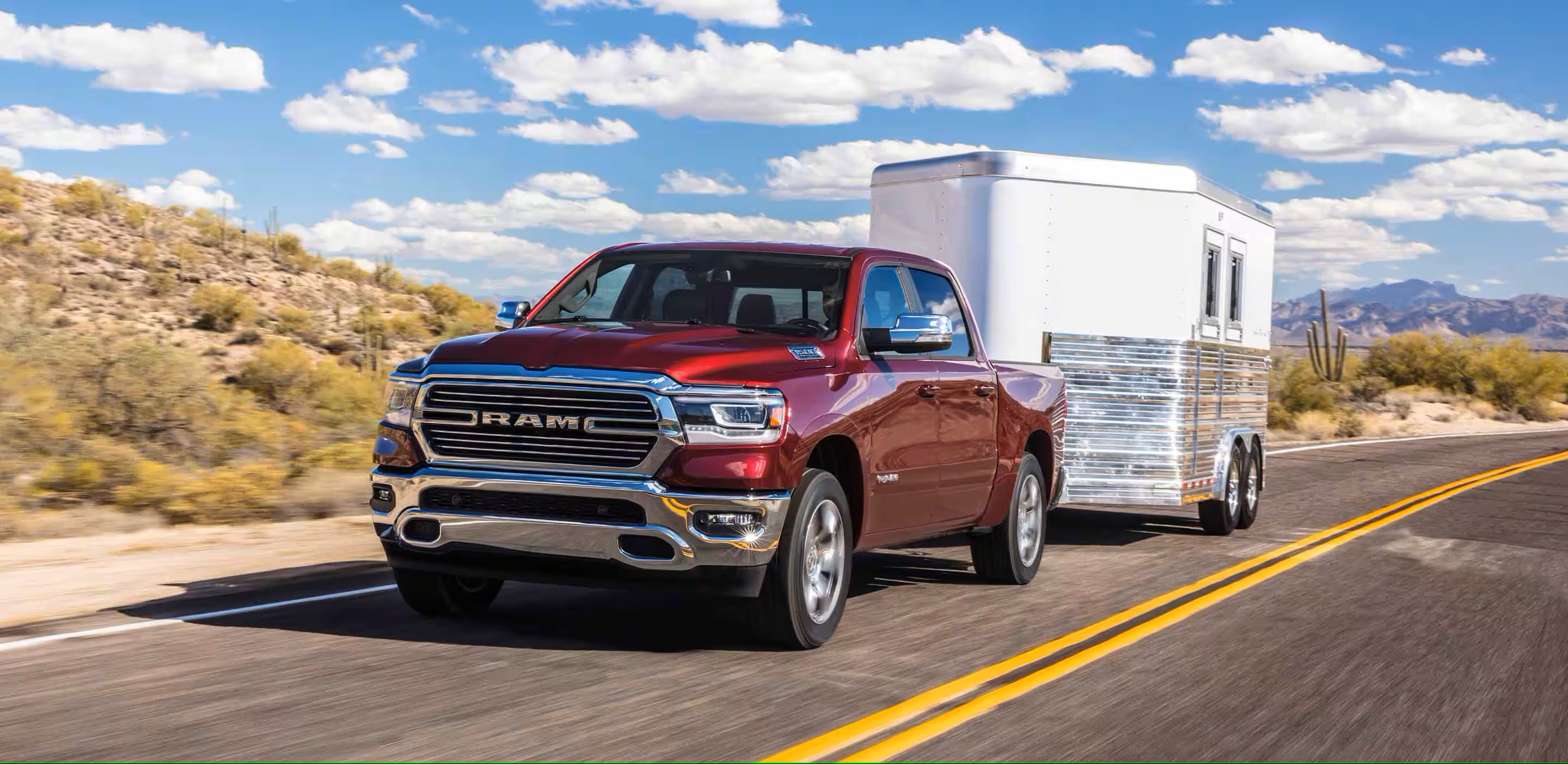 a red truck hauling a white trailer