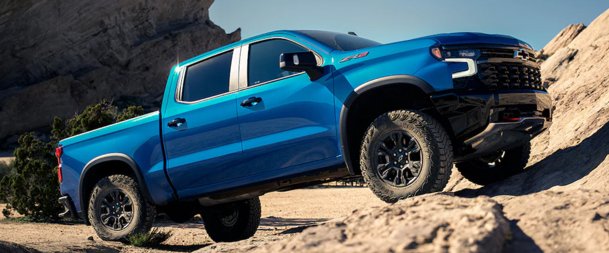 A blue truck parked on a rocky surface