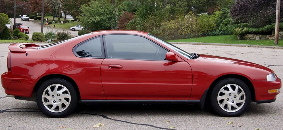 1995 red Honda Prelude parked in the street; profile shot