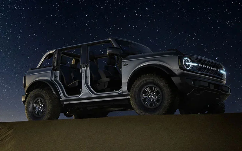 image of black ford bronco under star filled night sky