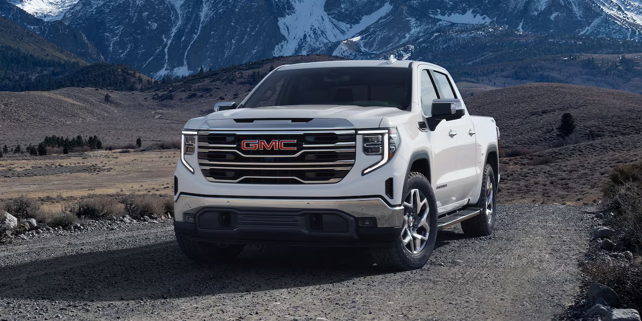 a white truck on gravel road