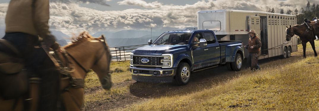 Blue 2024 Ford Super Duty Towing a Horse Trailer