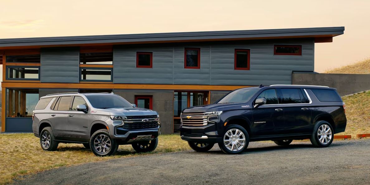 pictured left to right: gray 2023 Chevrolet Suburban and a black 2023 Chevrolet Suburban