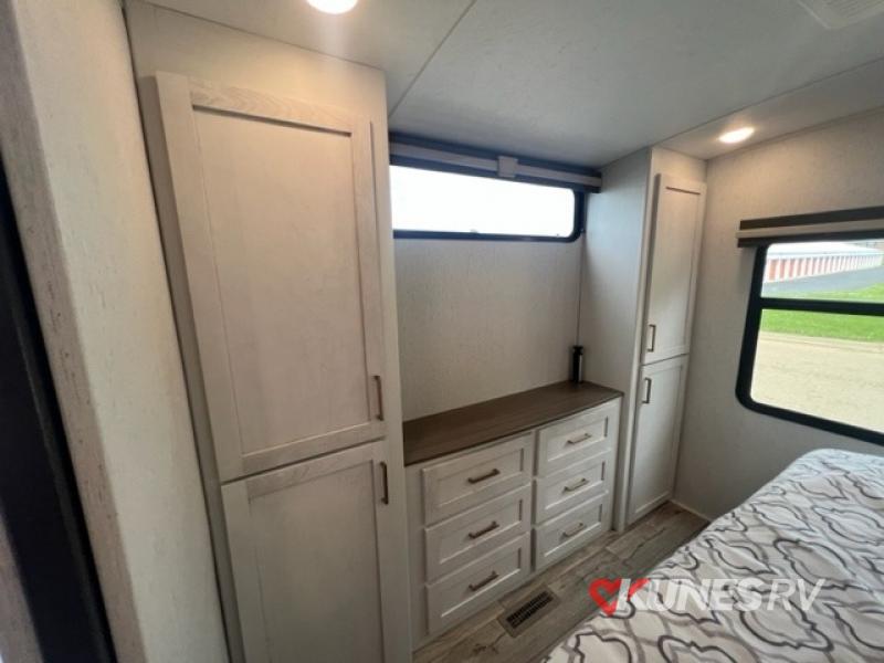 large wardrobe and entertainment center in master bedroom in Dutchmen RV Atoria 2913FK