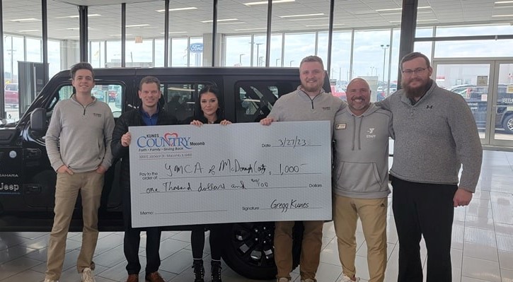 Kunes Auto Group of Macomb sales team presents one-thousand dollar check to Macomb's YMCA