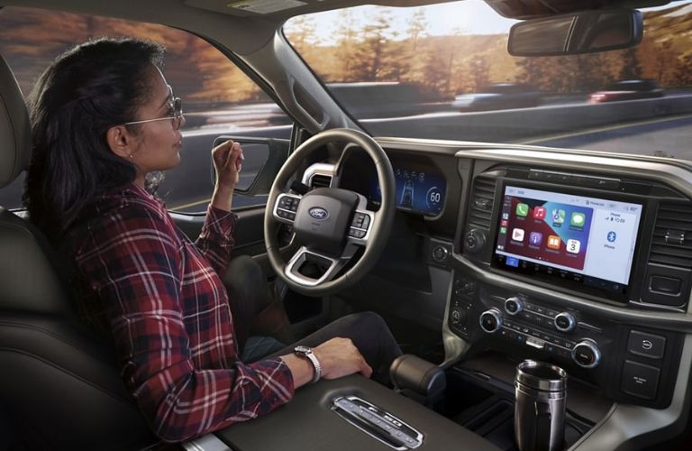 Woman in Driver's Seat of 2024 Ford F-150 Using Ford BlueCruise