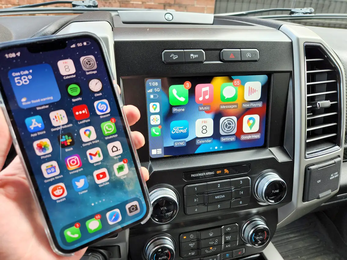 Apple CarPlay interface on an iPhone and vehicle's infotainment center