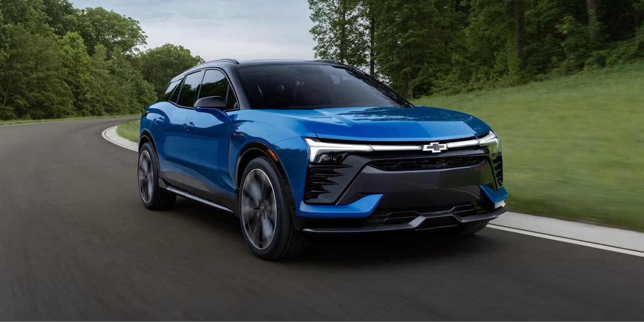 A blue blazer ev driving on a road.