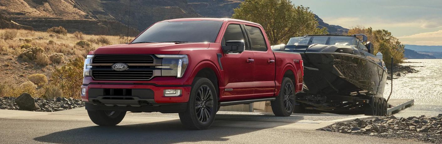 Red 2025 Ford F-150 Pulling a Boat Out of the Water