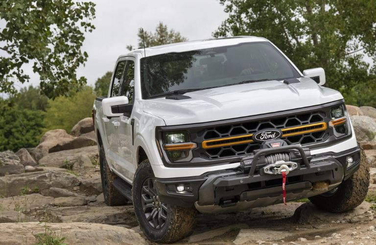 White 2024 Ford F-150 Tremor on Rocky Trail with Winch