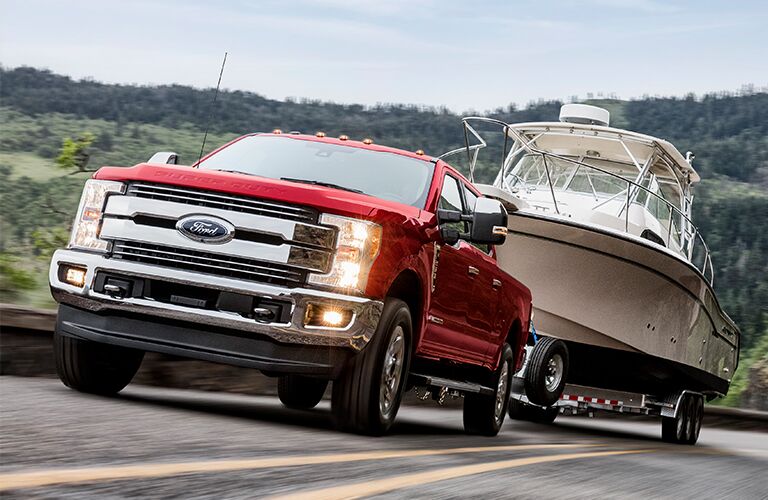 front view of a red 2019 Ford F-250 Super Duty towing a boat