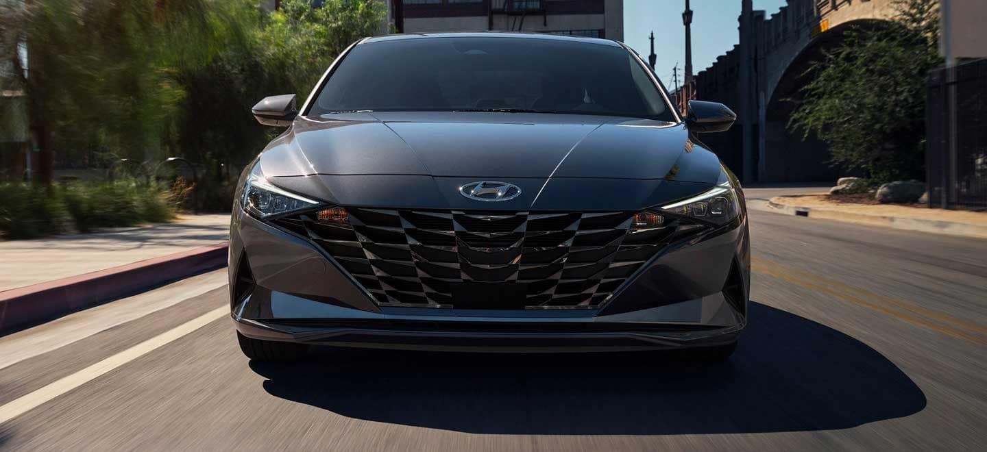 A 2021 Hyundai Elantra driving on a road.