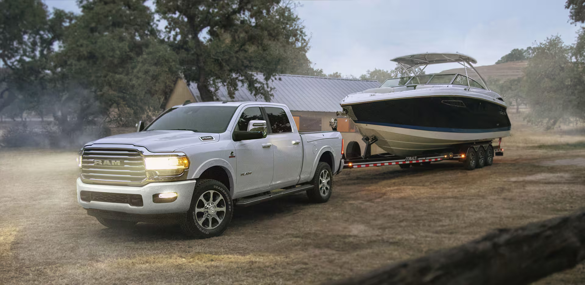 A white ram 2500 pulling a boat.