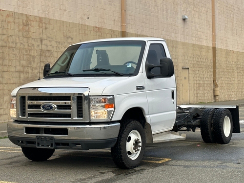 a Ford E350 SD white base with a tan brick background