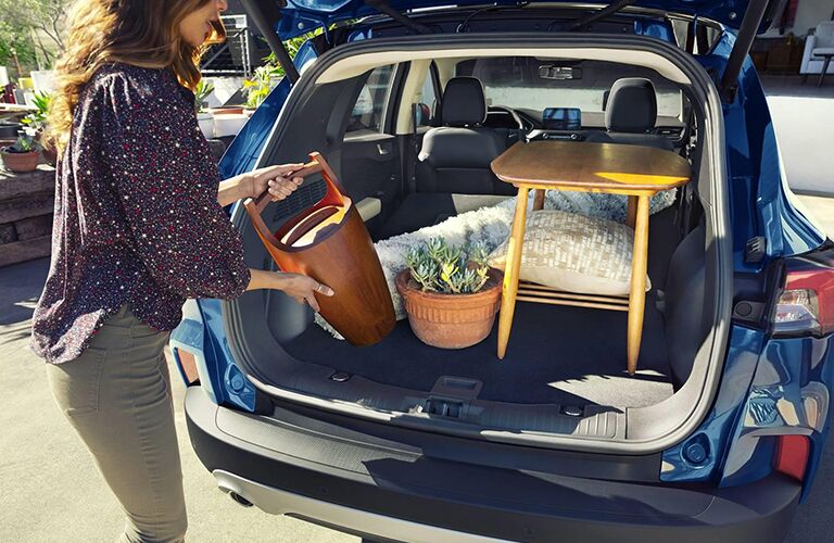 woman loading up rear cargo area of her 2021 Ford Escape