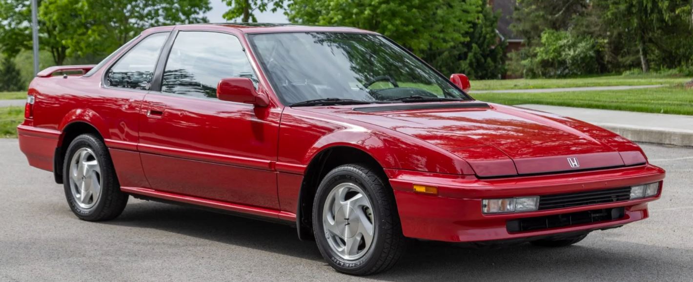 1991 red Honda Prelude parked on the street
