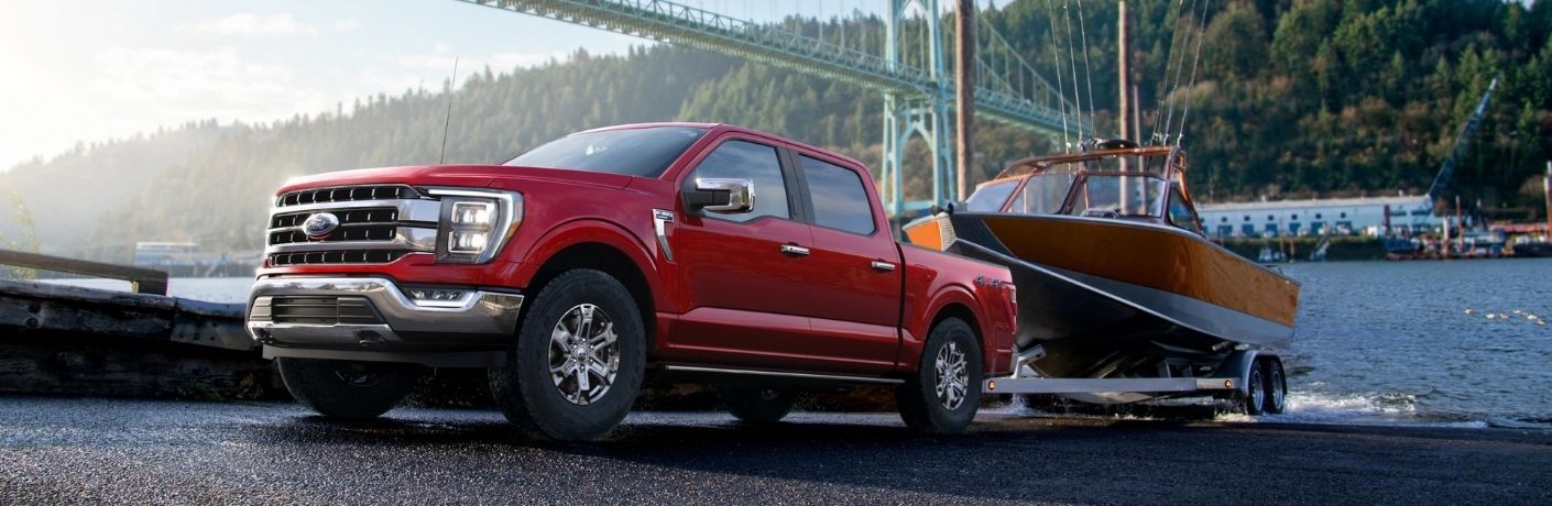 Red 2022 Ford F-150 Towing a Boat