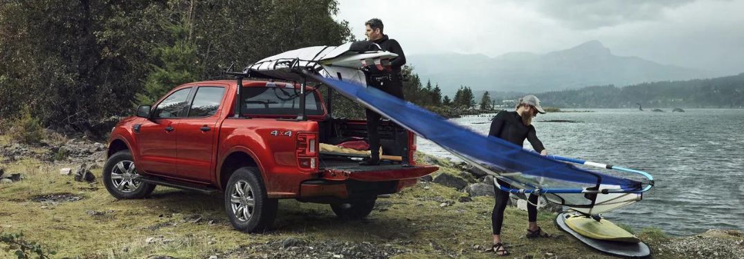 Men Unloading Sailboats from Bed of Red 2023 Ford Ranger by Water