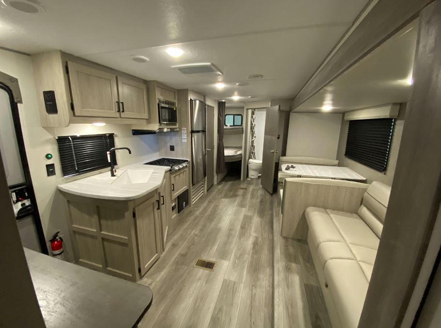 Coachmen Catalina Series 8 Travel Trailer 261BHS view from kitchen looking back towards the bunkroom and bathroom