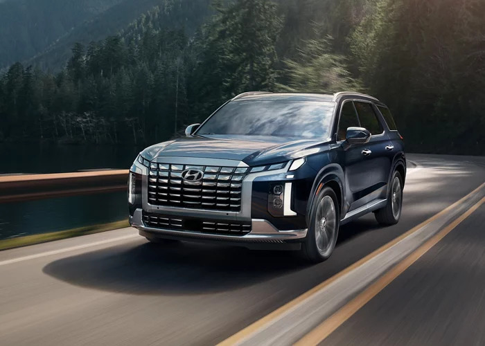 2024 Hyundai Palisade driving on a road.