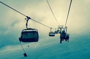 skiers riding a gondola