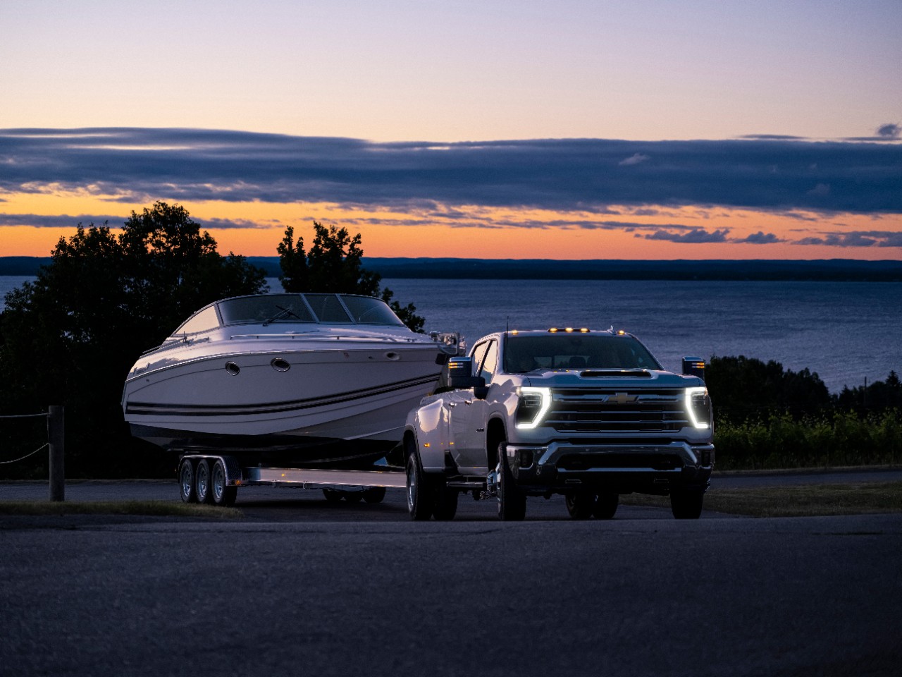 Chevrolet Silverado pulling a boat at sundown