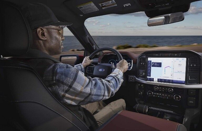 man using the infotainment system in his 2021 Ford F-150 Hybrid