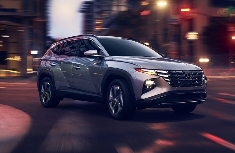 Silver 2022 Hyundai Tucson on a City Street at Night