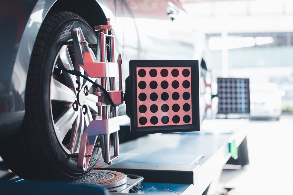 vehicle on a wheel alignment and tire balance machine