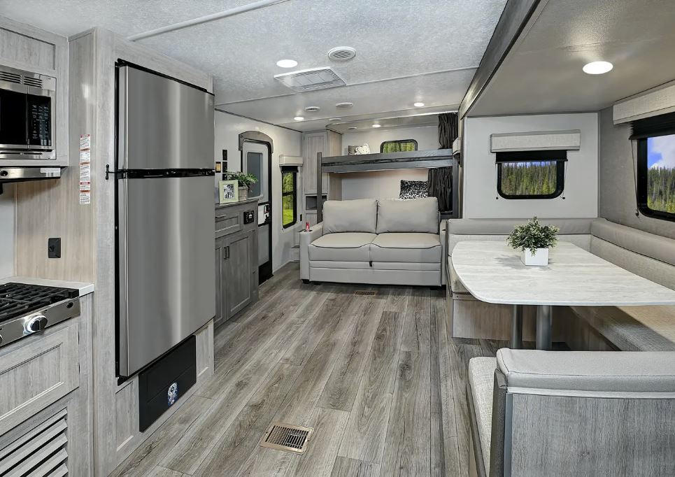 Coachmen Catalina Series 8 Travel Trailer 71DBSS view from kitchen looking back towards the loveseat and bunks