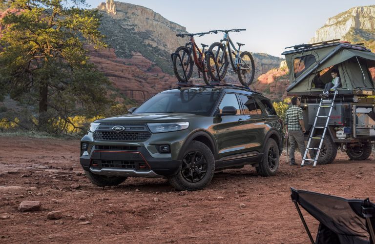 Green 2024 Ford Explorer Timberline in a Desert with a Small Trailer and Tent