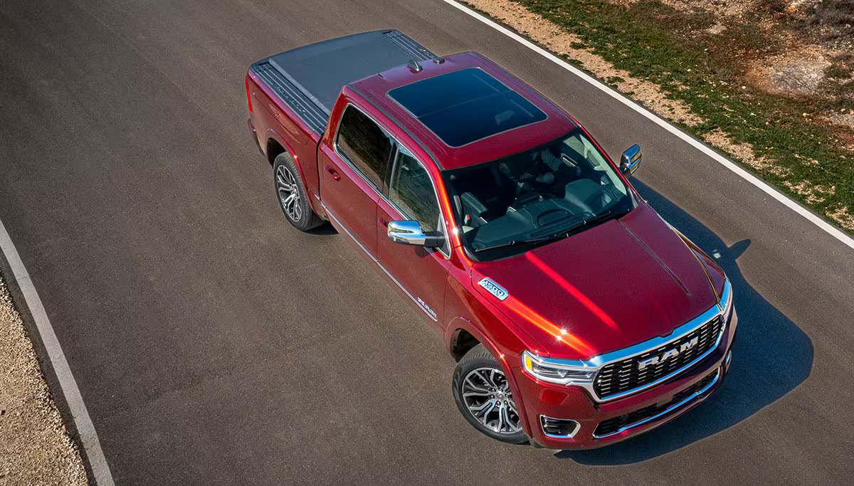 A Red 2025 Ram 1500 parked in the road.