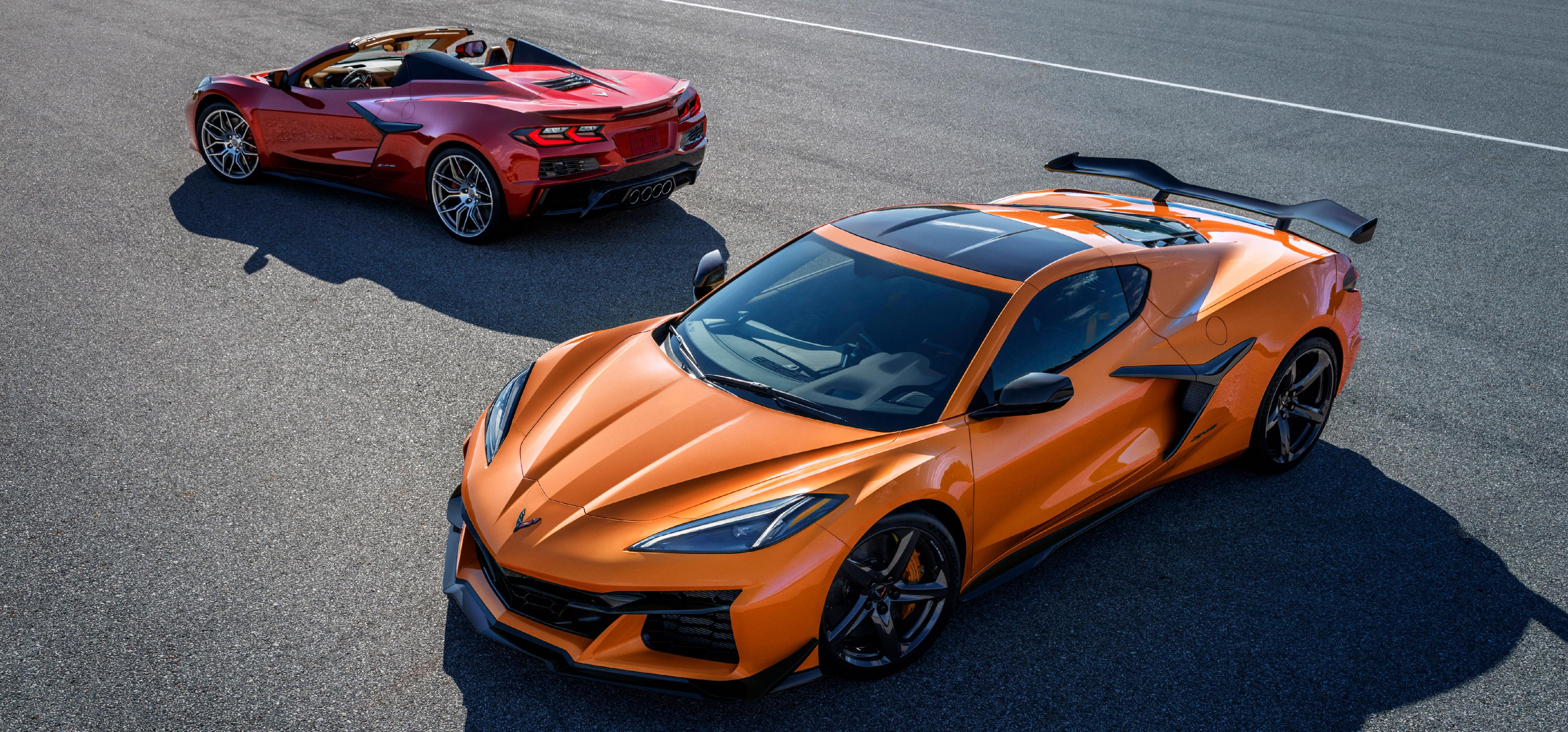 pictured on a roadway: red 2023 Corvette Z06 in back, orange 2023 Corvette Z06 in front