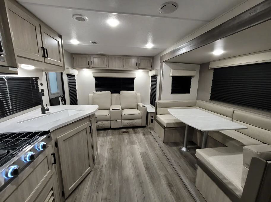 Coachmen Catalina Series 8 Travel Trailer 231MKS view from kitchen looking back towards the reclining chairs