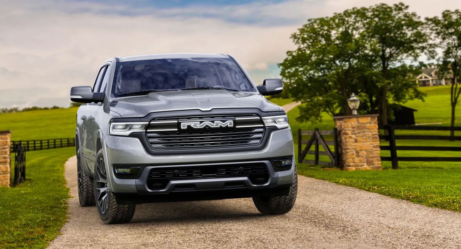 silver 2025 Ramcharger parked in a rural gravel driveway