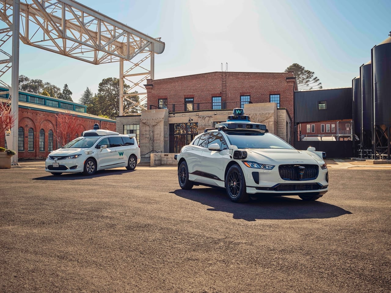 Waymo's autonomously driven Jaguar I-PACE electric SUV and legacy Chrysler Pacifica minivan.