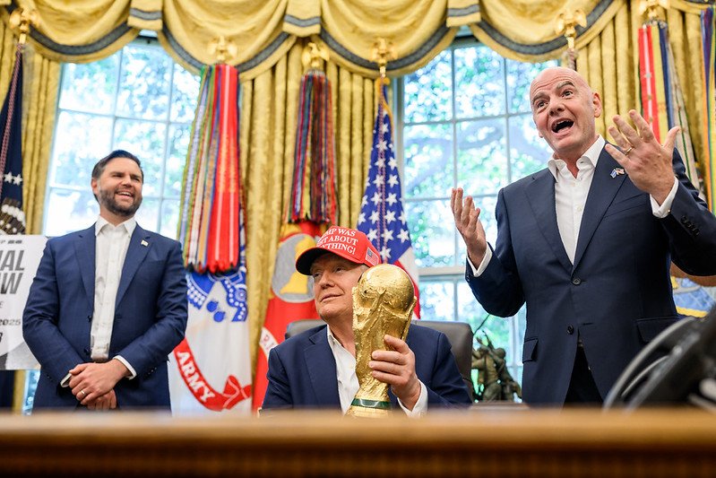 U.S. President Donald Trump, flanked by Vice President JD Vance and FIFA President Gianni Infantino.