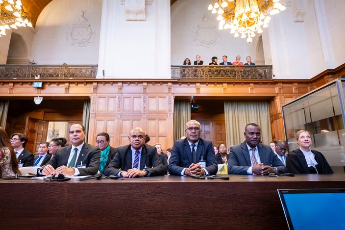 Ralph Regenvanu (left) sits with other Representatives of Vanuatu and the Melanesian Spearhead Group. Photograph: UN Photo/ICJ-CIJ/Frank van Beek. Courtesy of the ICJ. All rights reserved.